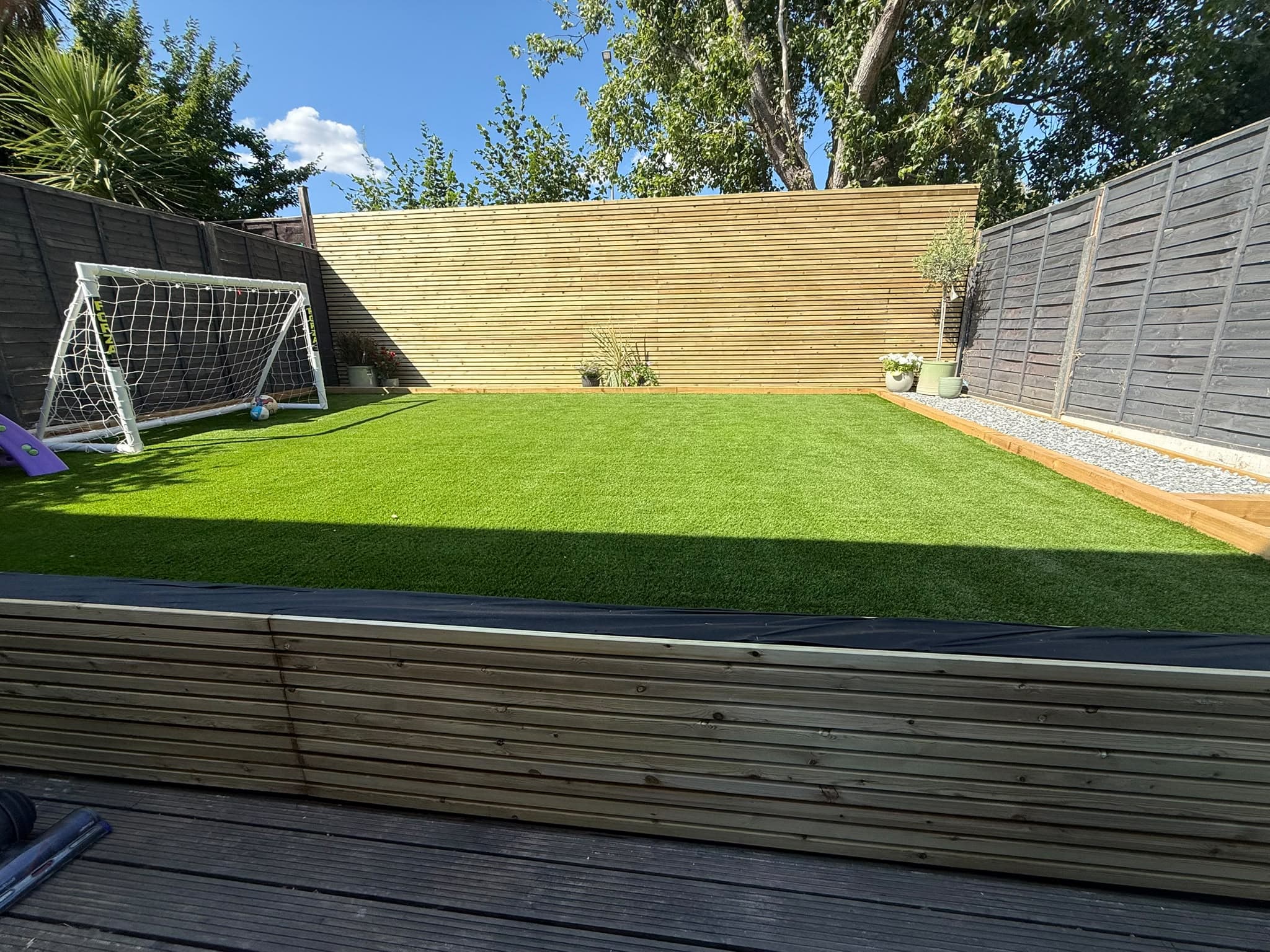 Cedar slat fencing and lawn